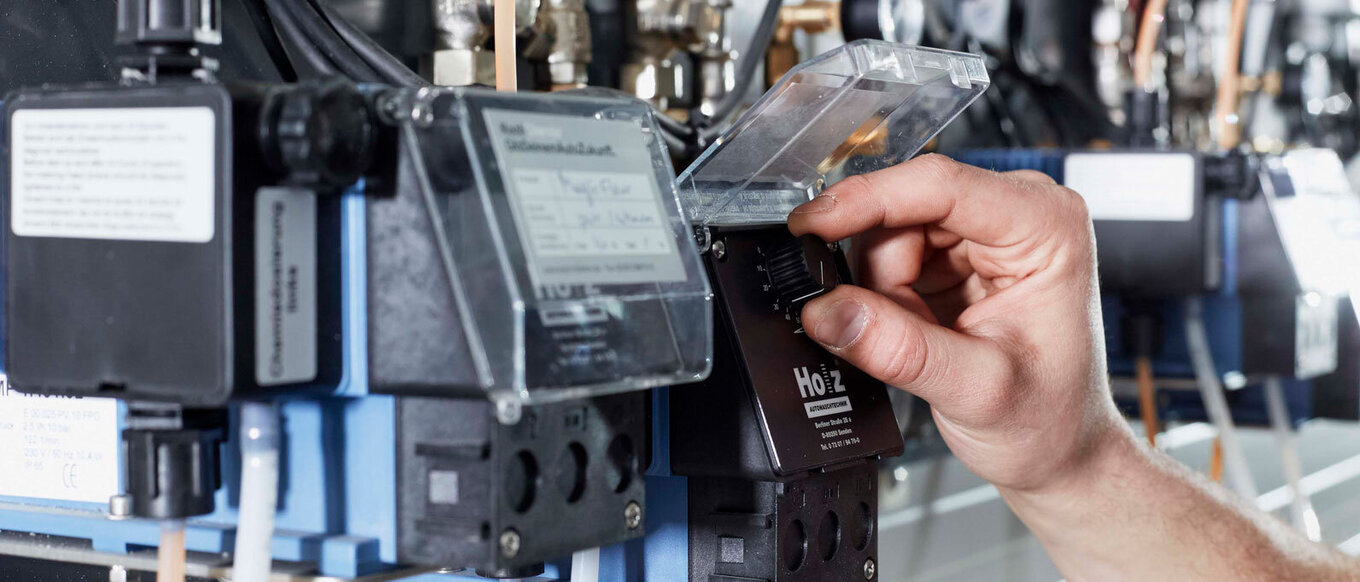 Close-up of an employee's hand operating one of our machines