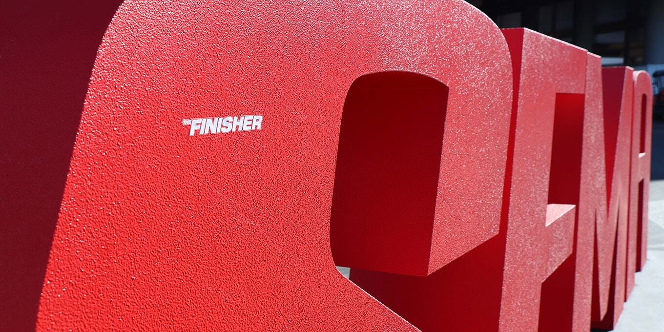 "The Finisher" logo sticker on the SEMA Show logo display