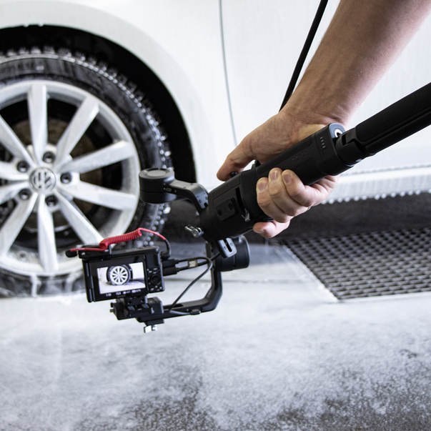 Making-of shot of a camera filming the cleaning process of a car