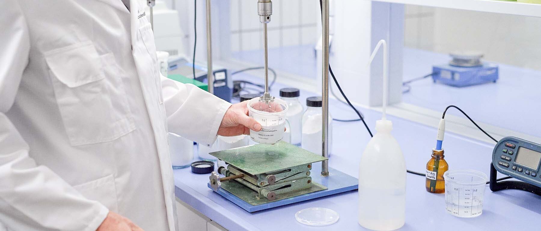 Employees performing a chemical test on a device