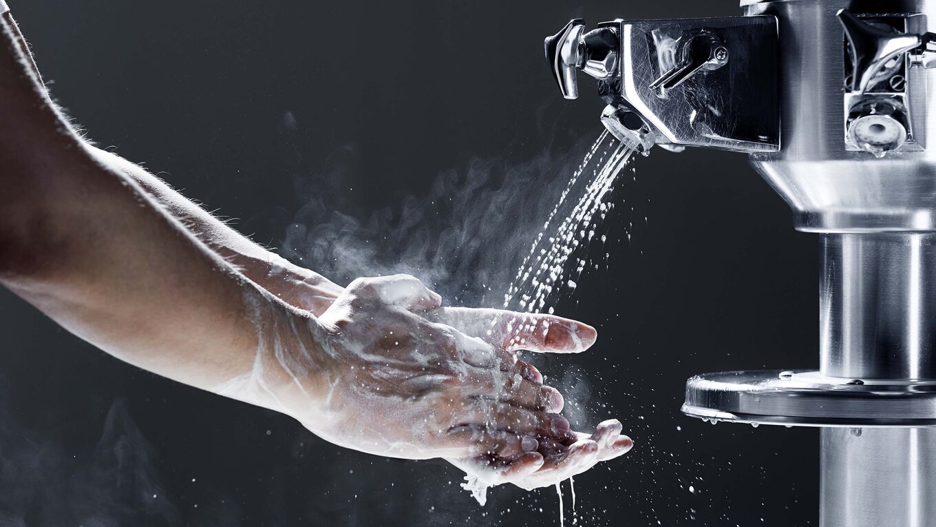 Person washing handy with steaming water