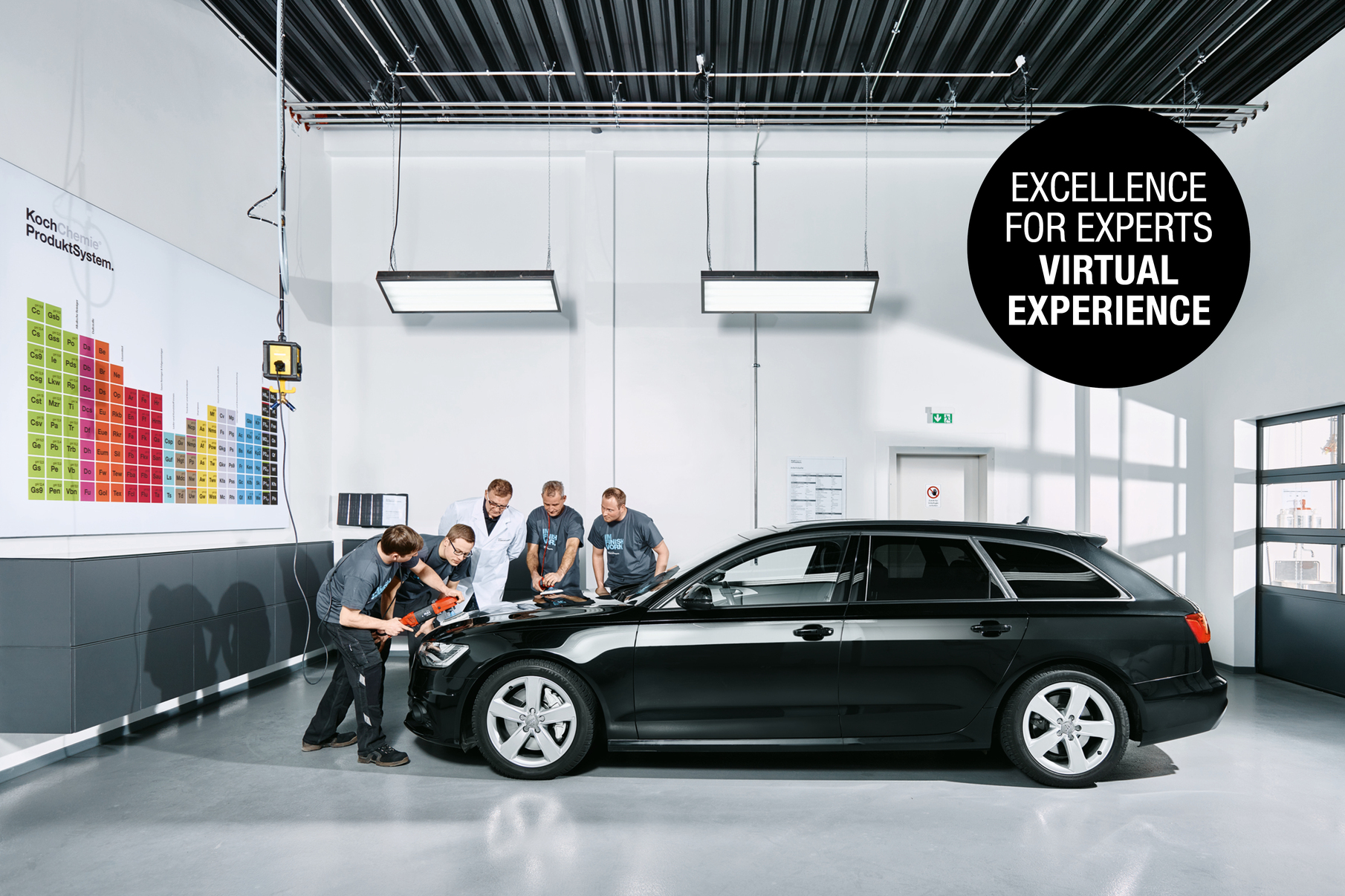 Employees applying products on a black car with a polishing machine